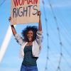 An African American protester woman with placard protesting for women's rights