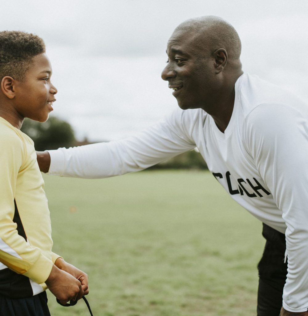 Football coach advising the goalkeeper Football coach advising the goalkeeper
