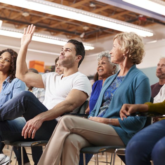 Man Asking Question At Neighborhood Meeting In Community Center