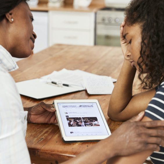 Mother Helps Stressed Teenage Daughter With Homework