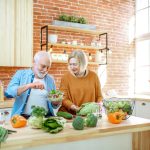 Senior couple with healthy food at home