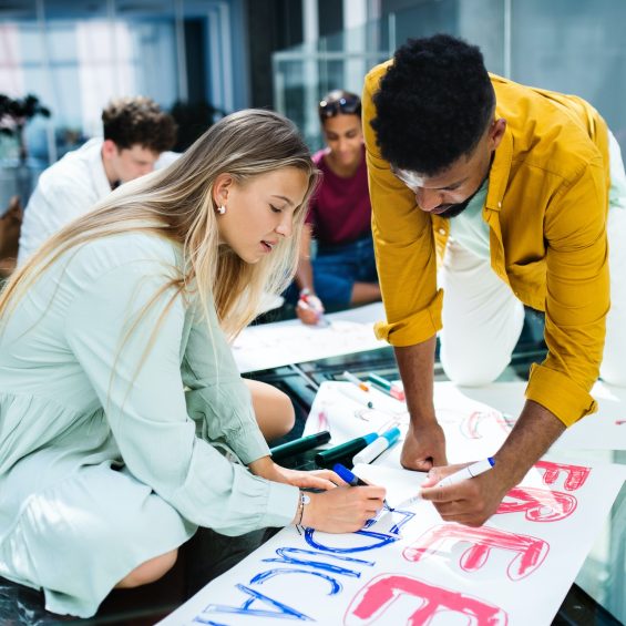 Students activists making banners for protest indoors, fighting for free education concept.