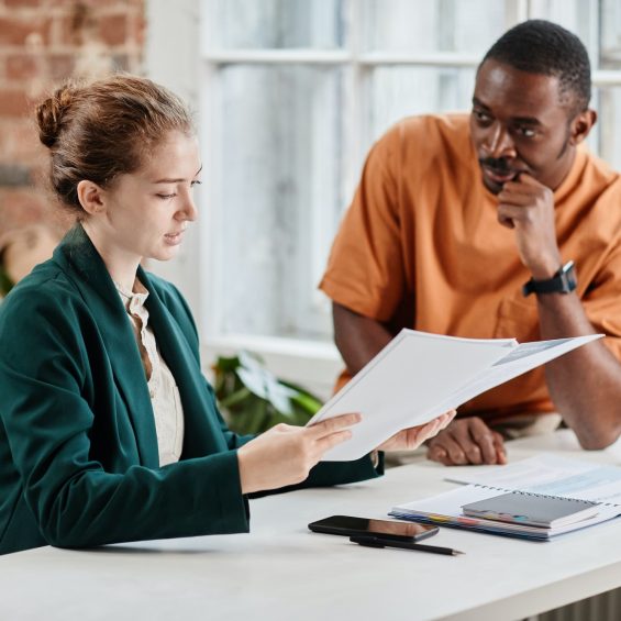 Young confident economist or lawyer checking documentation